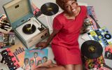 Beverley Knight sits surrounded by vinyl records by The Drifters