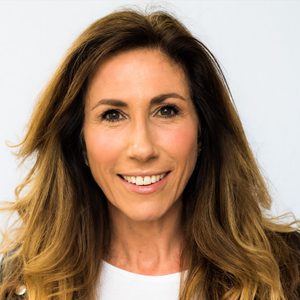 A friendly woman with long dark hair smiles