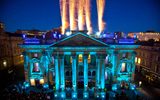 Fireworks explode in the sky above the theatre