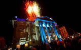 Fireworks light up the sky above the theatre as the crowds look on