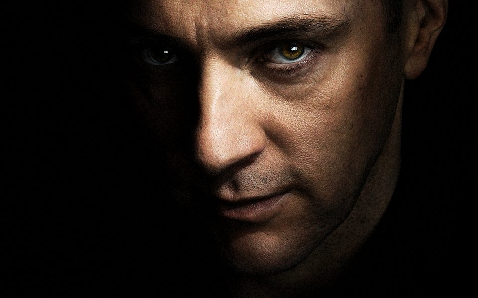 A man stares intensely towards the camera