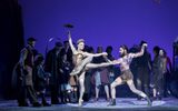 Two dancers perform in front of a watching crowd