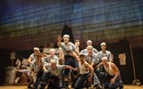 A group of navy sailors perform a song and dance routine