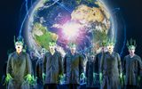 People dressed in black with greenery growing from their heads and fingers.