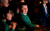 A boy looks towards the stage.