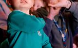 A boy gazes up at the stage.