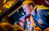 A young man looks at the stage.