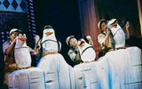 four penguin puppets are on an iceberg