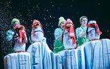 Four penguin puppets on an iceberg in woollen hats and scarves.