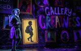 A young girl standing in front of a sign reading 'Gallery of Greatness'.