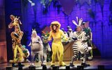 The cast dressed as animals dancing on the stage.