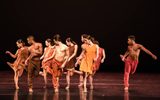 A large group of dancers all posing and looking away from the camera.