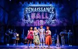 Four people dressed up, standing in front of a sign reading 'Renaissance Ball Ce Soir'