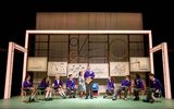 Students in a lesson all sitting in a semi circle talking.