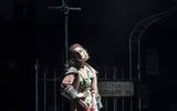 A female leans against a lamppost, she is in front of a Fitzroy Square street sign.