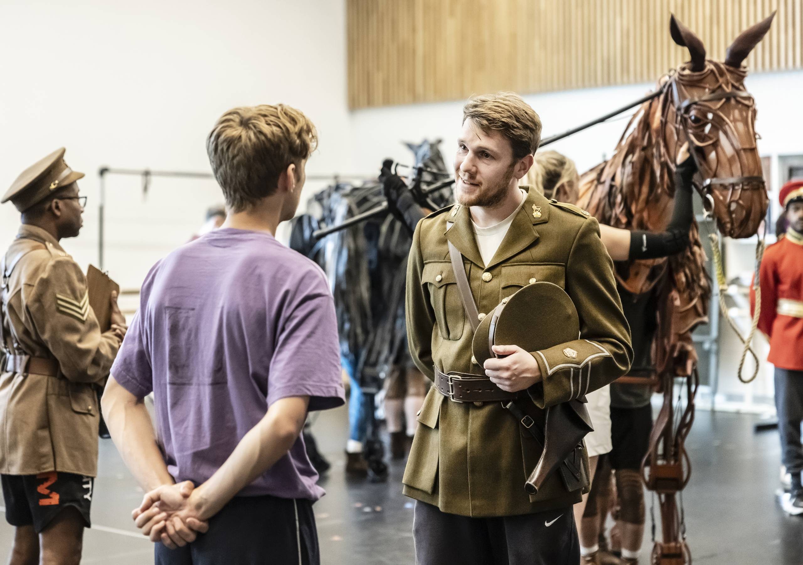 Chris Williams and the cast of War Horse in rehearsals. Credit Pamela Raith Photography.