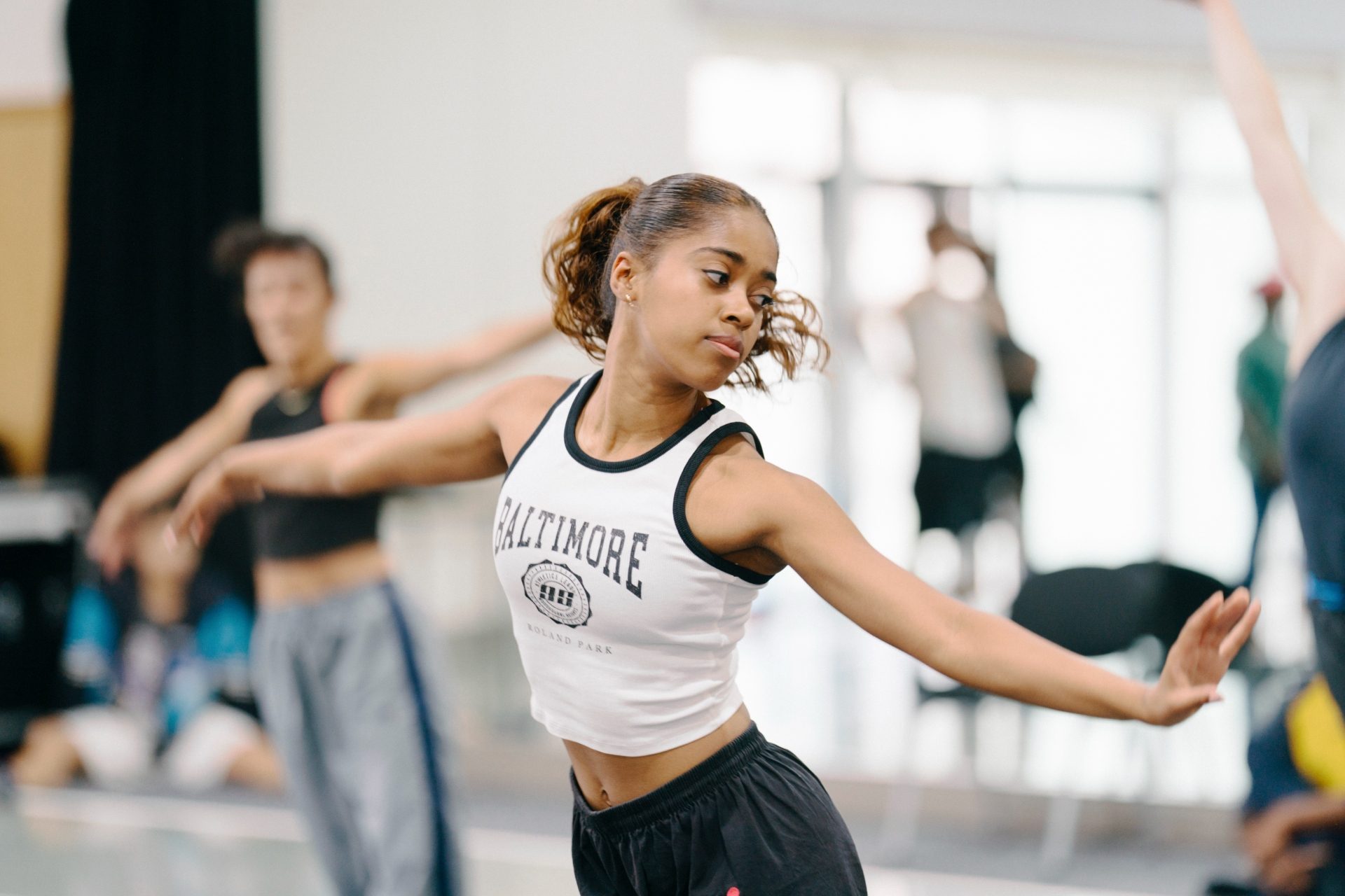 In reheasal for Susanna, the latest collaboration between Opera North and A girl with dark hair tied back dances. Phoenix Dance Theatre. Photo credit Tom Arber