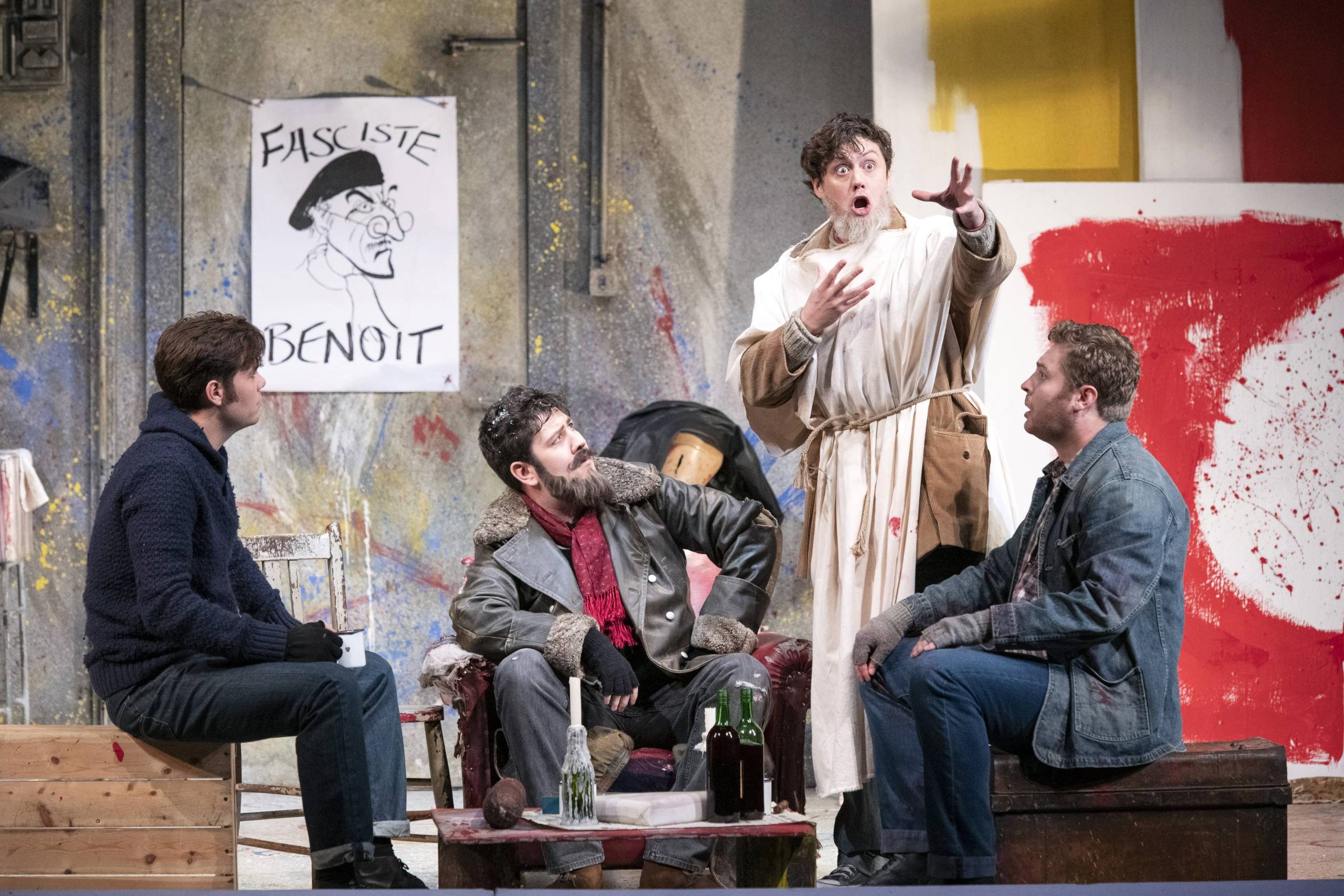 A Parisienne bohemian scene with men sat round talking.